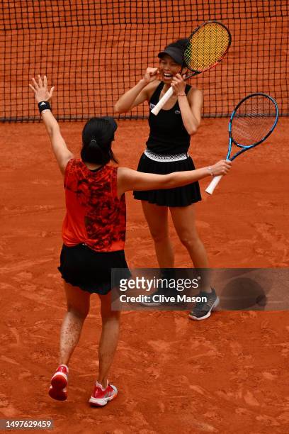 Xinyu Wang of People's Republic of China celebrates winning match point with partner Su-Wei Hsieh of Taipei against Leylah Fernandez of Canada and...