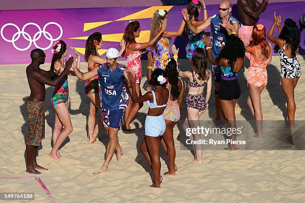 Phil Dalhausser of the United States and Todd Rogers of the United States run onto the court before the Men's Beach Volleyball Round of 16 match...