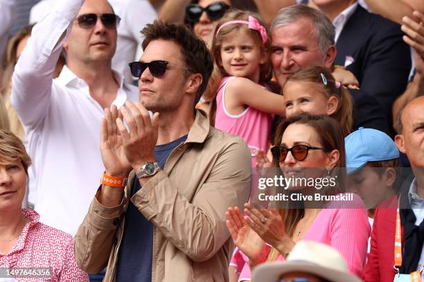 Tom Brady watches on from the crowd alongside Jelena Djokovic during the Men's Singles Final match between Novak Djokovic of Serbia and Casper Ruud...