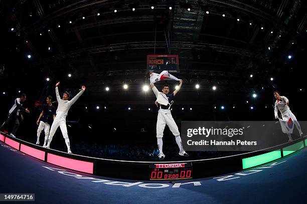 Team Korea celebrates after defeating Romania to win gold in the Men's Sabre Team Fencing on Day 7 of the London 2012 Olympic Games at ExCeL on...