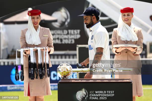 Virat Kohli of India walks past the ICC World Test Championship Mace on day five of the ICC World Test Championship Final between Australia and India...