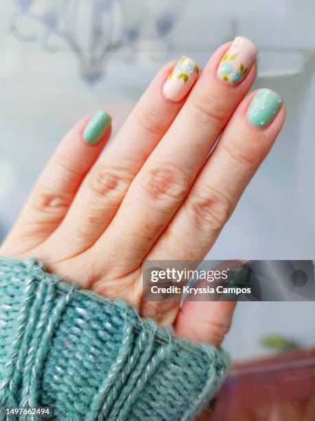 mint and skin tones nails art with rose flowers - aqua nail polish stock pictures, royalty-free photos & images