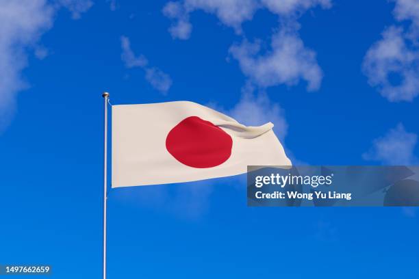 japan flag with blue sky background ,3d rendered - japanische flagge stock-fotos und bilder