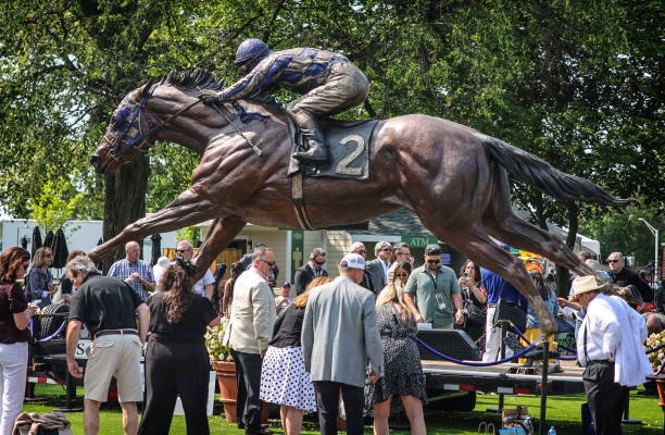 People gather around a giant statue of Secretariat at Belmont Park as they celebrate the 50th anniversary of Secretariat at the 2023 Belmont Stakes...