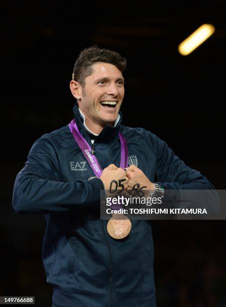 Italy's Aldo Montano celebrates the bronze medal on the podium of the men's sabre team as part of the fencing event of London 2012 Olympic games, on...
