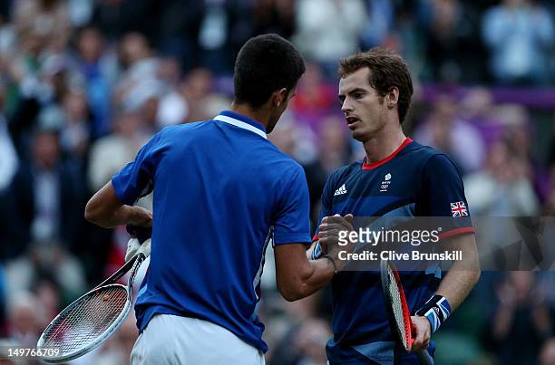 Andy Murray of Great Britain is congratulated by Novak Djokovic of Serbia after his 7-5, 7-5 win in the Semifinal of Men's Singles Tennis on Day 7 of...