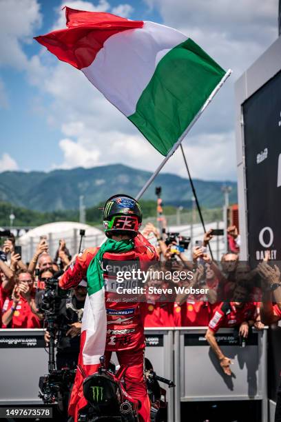 Francesco Bagnaia of Italy and Ducati Lenovo Team stands on his bike with the Italian flag during the Race of the MotoGP Gran Premio d'Italia Oakley...