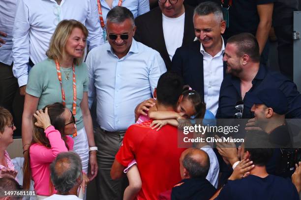 Novak Djokovic of Serbia celebrates winning match point with members of his family and team in the crowd against Casper Ruud of Norway in the Men's...