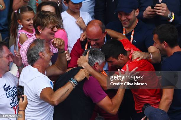 Novak Djokovic of Serbia celebrates winning match point with members of his family and team in the crowd against Casper Ruud of Norway in the Men's...
