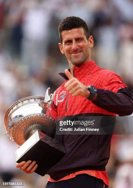 Novak Djokovic of Serbia celebrates with the winners trophy after victory against Casper Ruud of Norway in the Men's Singles Final match on Day...
