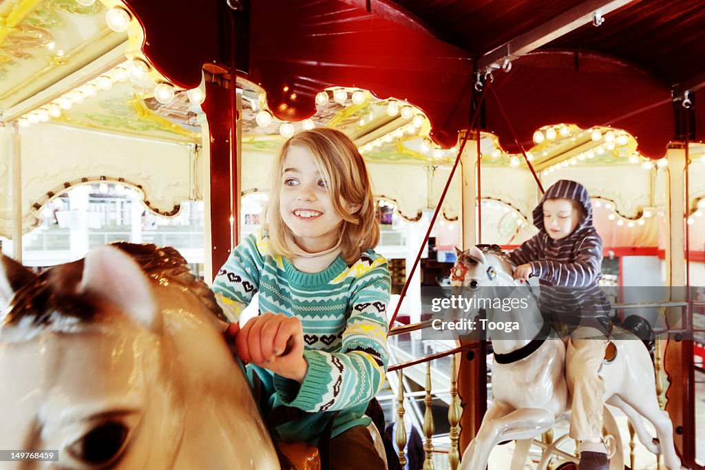 Girl and boy on carousel