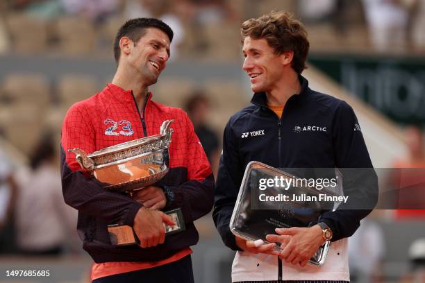 Novak Djokovic of Serbia and Casper Ruud of Norway pose with their winners and runners up trophies after the Men's Singles Final match on Day Fifteen...
