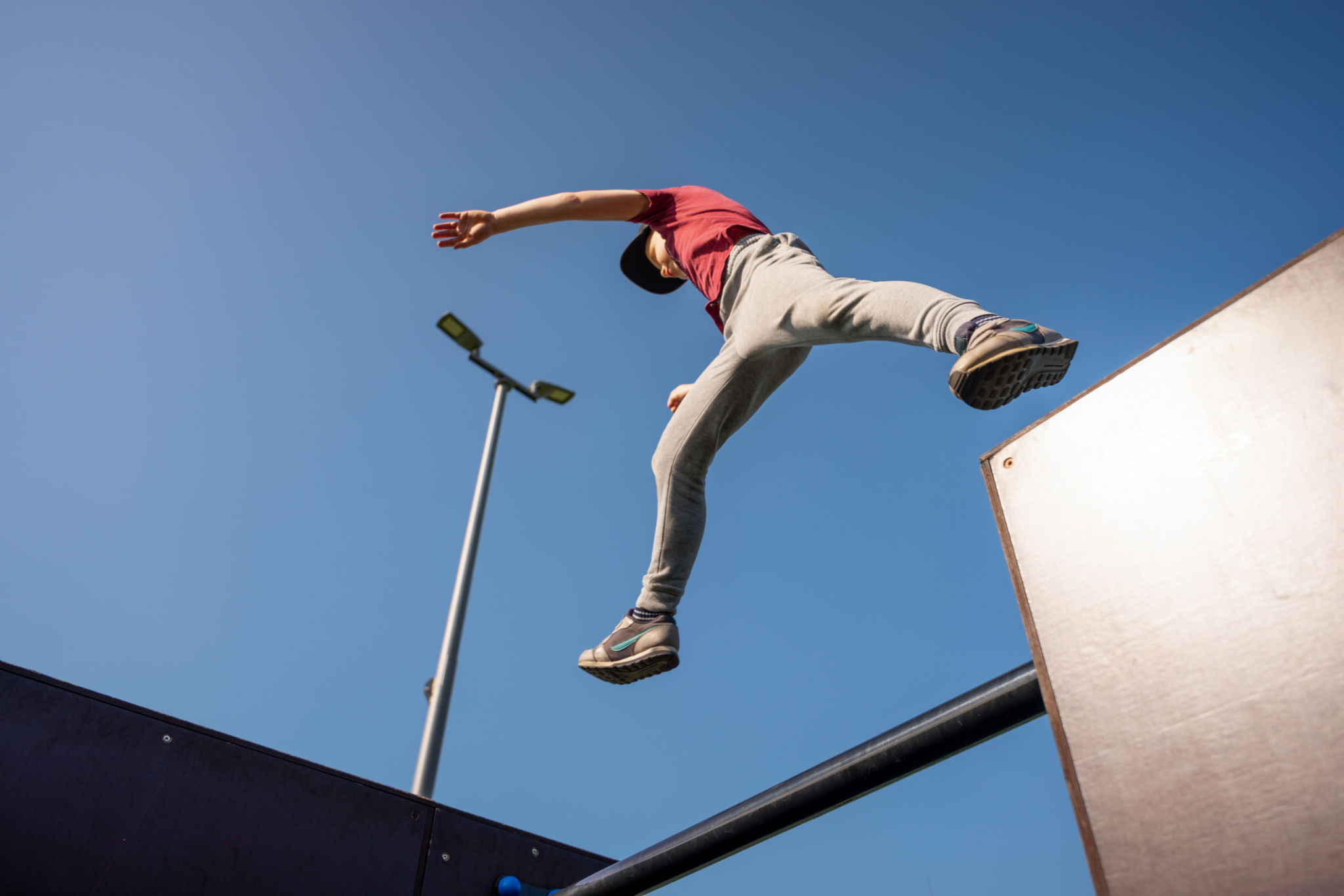 Boy jumping at free running sports ground in the morning Boy jumping at free running sports ground in the morning