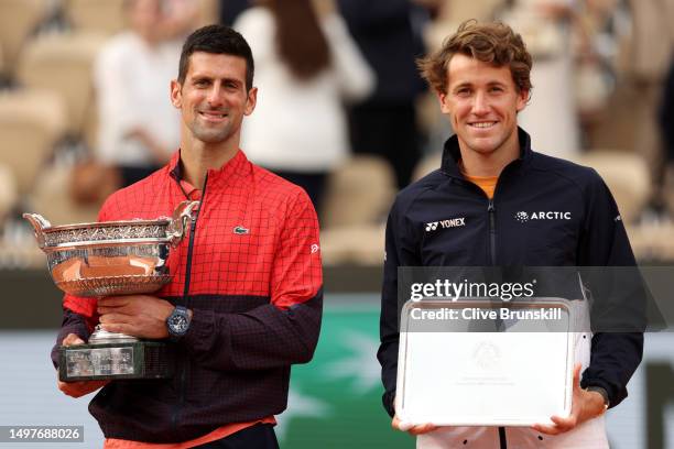 Novak Djokovic of Serbia and Casper Ruud of Norway pose with their winners and runners up trophies after the Men's Singles Final match on Day Fifteen...