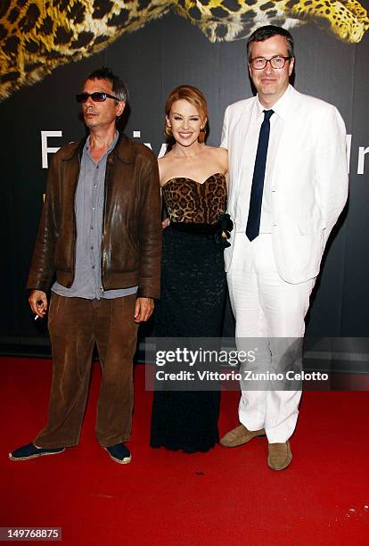 Leos Carax, Kylie Minogue, Olivier Pere attend the Swisscom Leopard of Honor To Leos Carax red carpet during the 65th Locarno Film Festiva lon August...