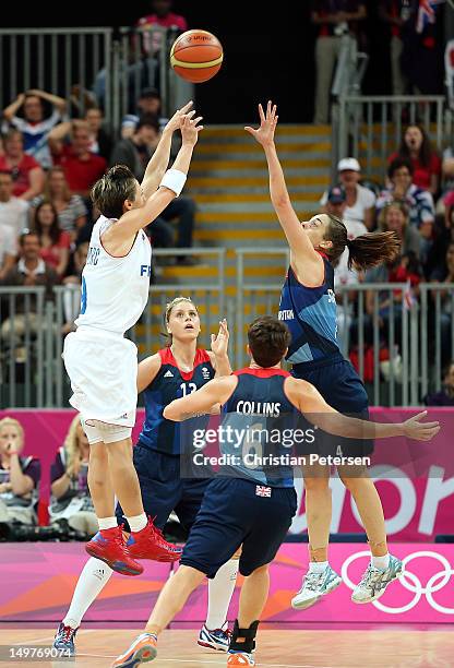 Celine Dumerc of France shoots the go ahead basket over Johannah Leedham, Natalie Stafford and Stef Collins of Great Britain in the final moments of...