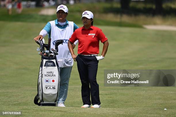 Haru Nomura of Japan and her caddie line up a shot from the 18th fairway during the final round of the ShopRite LPGA Classic presented by Acer at...