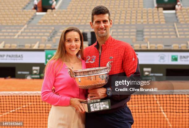 Novak Djokovic of Serbia and Partner, Jelena Djokovic pose for a photograph with the winners trophy after the Men's Singles Final match on Day...