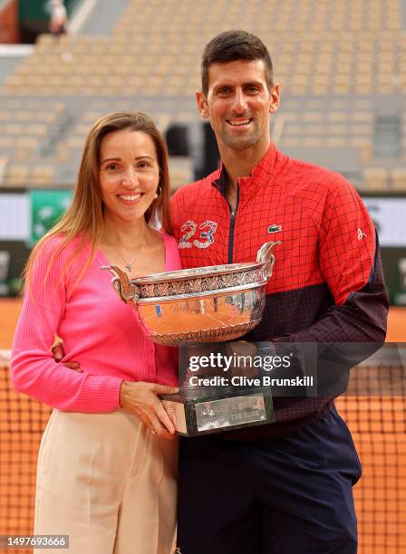 Novak Djokovic of Serbia and Partner, Jelena Djokovic pose for a photograph with the winners trophy after the Men's Singles Final match on Day...