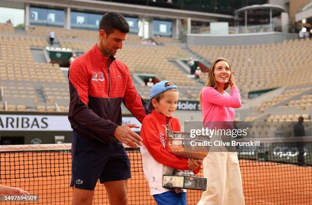 Novak Djokovic of Serbia, partner, Jelena Djokovic and his child pose for a photograph with the winners trophy after the Men's Singles Final match on...