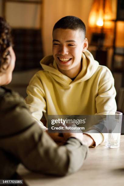 caring mother gently caressing teenage son's face and giving heartfelt advice - eastern europe stock pictures, royalty-free photos & images