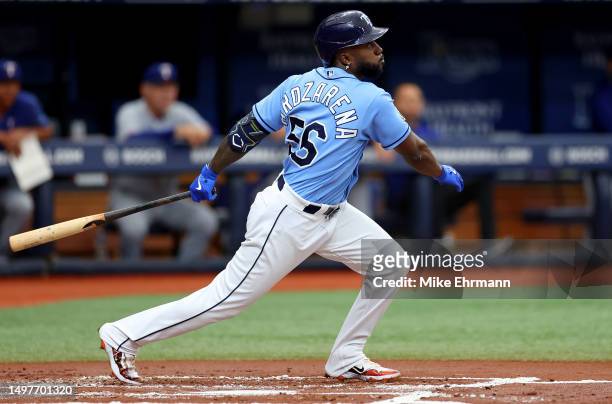 Randy Arozarena of the Tampa Bay Rays hits an RBI single in the first inning during a game against the Texas Rangers at Tropicana Field on June 11,...