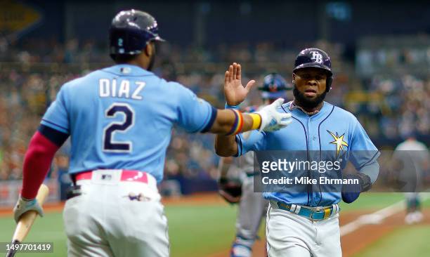 Manuel Margot of the Tampa Bay Rays is congratulated after scoring a run in the second inning during a game against the Texas Rangers at Tropicana...