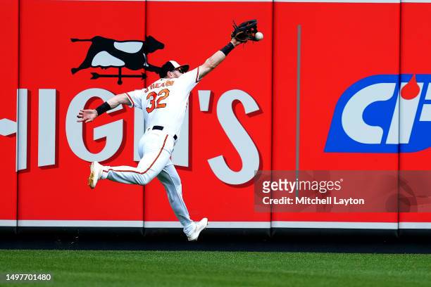 Ryan O'Hearn of the Baltimore Orioles misses a ball hit by Bobby Witt Jr. #7 of the Kansas City Royals in the first inning to allow a run to score...