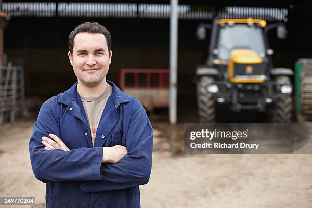 young farmer on his farm - overall stockfoto's en -beelden