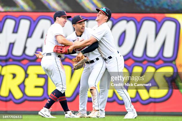 Will Brennan, Steven Kwan and Myles Straw of the Cleveland Guardians celebrate the team's 5-0 win over the Houston Astros at Progressive Field on...