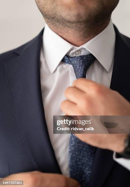 the perfect outfit means a perfect day - adjusting suit stock pictures, royalty-free photos & images