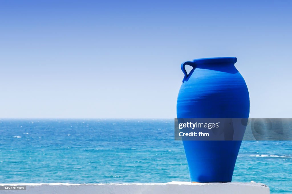 Blue amphora and sea in background