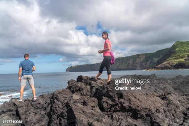 two people on the coast near mosteiros on sao miguel, azores - ponta delgada stock pictures, royalty-free photos & images