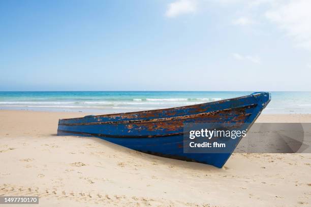 old rowboat on the beach - tariffa stock pictures, royalty-free photos & images