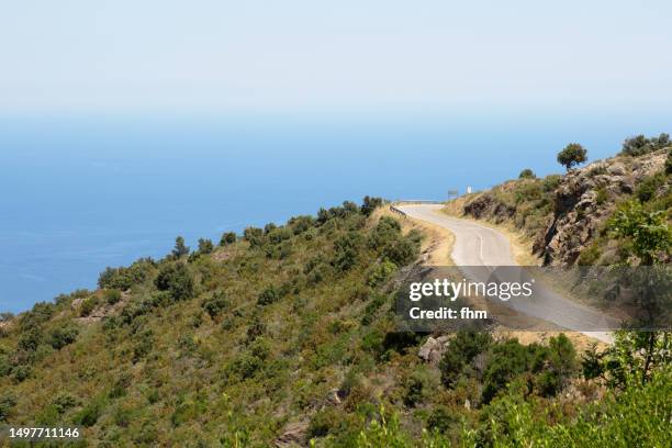 curvy road in the mountains near the mediterranean sea - valley side stock-fotos und bilder