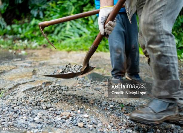 volunteers cleaning the broken road during community cleanup - woman leg spread stock pictures, royalty-free photos & images