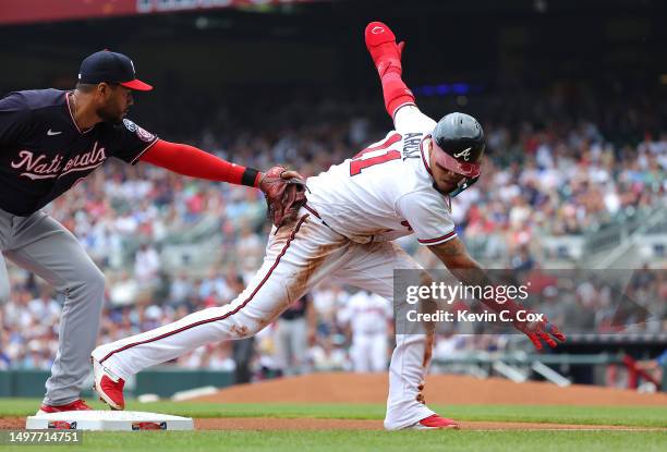 Orlando Arcia of the Atlanta Braves is safe at third base under the tag by Jeimer Candelario of the Washington Nationals on a single by Michael...