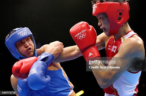 Serik Sapiyev of Kazakhstan in action with Yasuhiro Suzuki of Japan during the Men's Welter Boxing on Day 7 of the London 2012 Olympic Games at ExCeL...