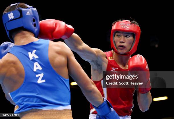 Serik Sapiyev of Kazakhstan in action with Yasuhiro Suzuki of Japan during the Men's Welter Boxing on Day 7 of the London 2012 Olympic Games at ExCeL...