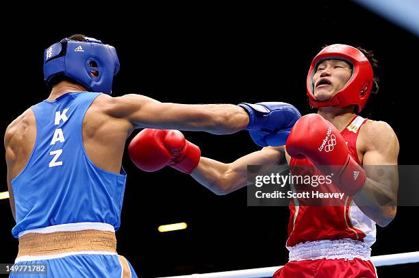 Serik Sapiyev of Kazakhstan in action with Yasuhiro Suzuki of Japan during the Men's Welter Boxing on Day 7 of the London 2012 Olympic Games at ExCeL...