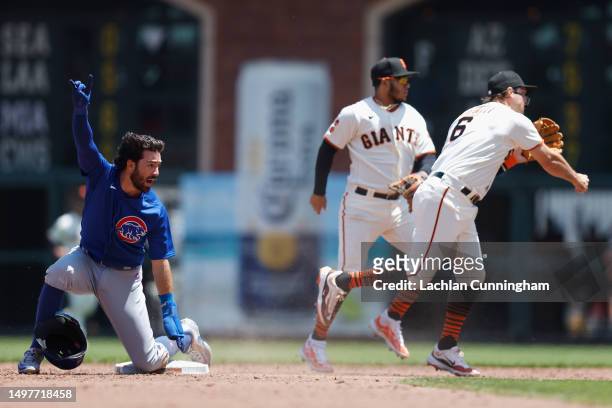 Base runner Dansby Swanson of the Chicago Cubs appeals to the dugout after fielder Casey Schmitt of the San Francisco Giants attempted to get the...