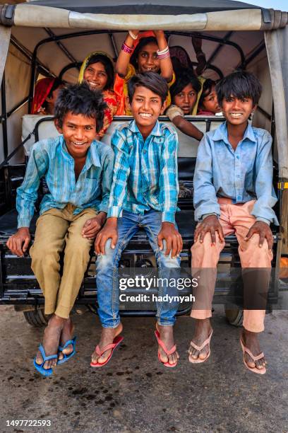 group of happy gypsy indian children riding tuk-tuk, india - rajasthani youth stockfoto's en -beelden