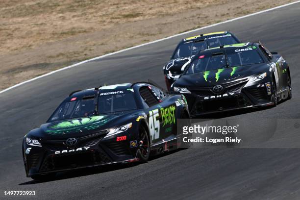 Tyler Reddick, driver of the The Beast Unleashed Toyota, Ty Gibbs, driver of the Monster Energy Toyota, and AJ Allmendinger, driver of the Gabriel...