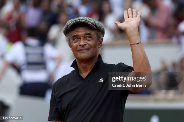 Trophy presenter Yannick Noah acknowledges the crowd during the trophy ceremony following the Men's Singles Final match between Novak Djokovic of...