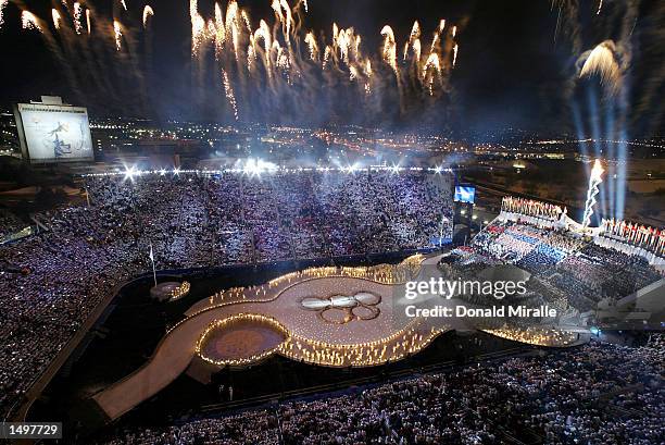 Fireworks light up the sky above the stadium for the grand finale of the Opening Ceremony of the 2002 Salt Lake City Winter Olympic Games at the...