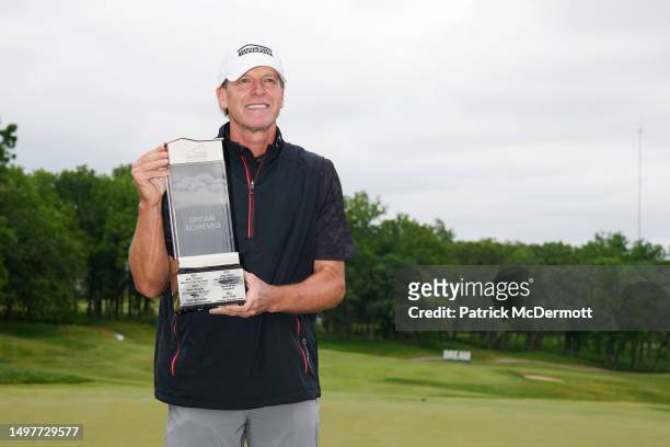 Steve Stricker of United States holds the winner's trophy on the 18th green after winning the American Family Insurance Championship at University...