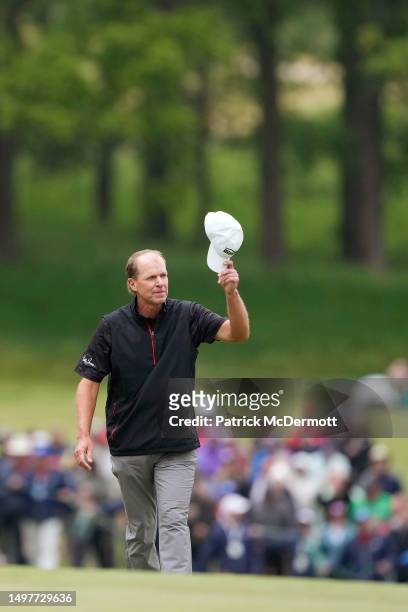 Steve Stricker of United States waves to the crowd as he walks on 18th fairway during the final round of the American Family Insurance Championship...