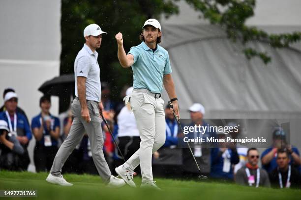 Tommy Fleetwood of England reacts on the 18th green after making a putt on the first playoff hole to force a second playoff as Nick Taylor of Canada...