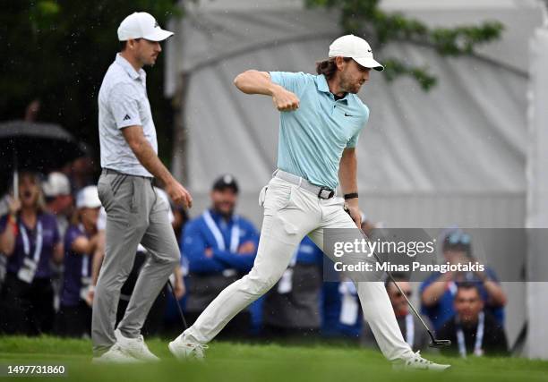 Tommy Fleetwood of England reacts on the 18th green after making a putt on the first playoff hole to force a second playoff as Nick Taylor of Canada...