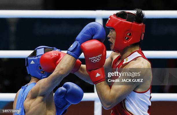 Yasuhiro Suzuki of Japan defends against Serik Sapiyev of Kazakhstan during their round of 16 Welterweight match of the London 2012 Olympic Games at...